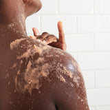 Person exfoliating with Peach Body Scrub